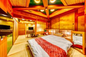a bedroom with a large bed in a room at Hotel Chronos -Adult Only in Fushimi