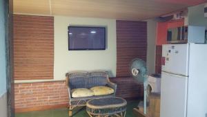 a kitchen with a couch and a tv and a refrigerator at Montevideo Apartamento centro a estrenar comodo in Montevideo