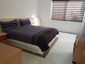 a bedroom with a large bed in a white room at ACAPULCO Vidanta Villa alberca privada acceso playa in Acapulco