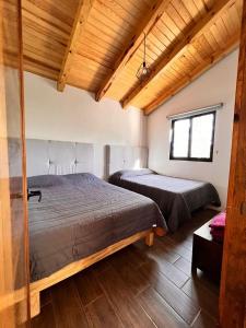 Postel nebo postele na pokoji v ubytování Cabaña "Alexa", en el corazón del bosque de Mazamitla