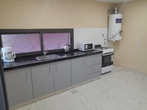 a kitchen with a sink and a counter top at Complejo Villa Maria in Ciudad Lujan de Cuyo