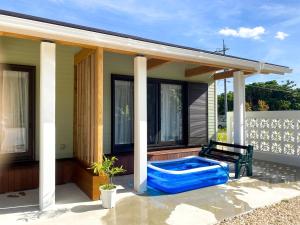 a house with a hot tub on a patio at Yonehara Beach Stay LUANA - Vacation STAY 38711v in Fukai