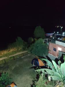 a view of a tent in a yard at night at Espacio para acampar en la Isla de Janitzio in Pátzcuaro