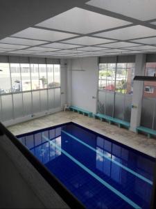 a large swimming pool with blue water in a building at Acogedor Apto Sector Tintal in Bogotá