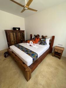 a woman laying on a bed in a bedroom at The View of Zanzibar in Michamvi