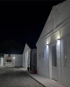 un par de edificios blancos por la noche en Pueblo Dorado Departamentos en Malargüe