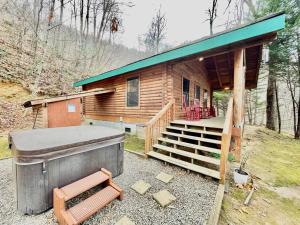 a log cabin with a hot tub and a deck at Good Life Cabin 2 in Bryson City