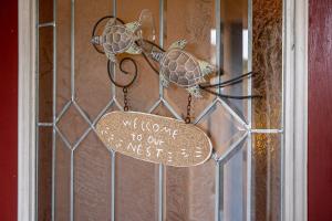 a sign on a door with two turtles on it at Private Pool Home - Just Miles from Sanibel and Fort Myers Beach - home in Fort Myers +14 photos