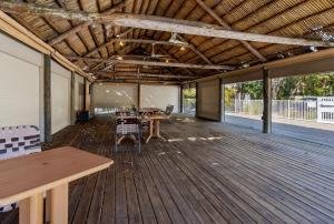 a large room with a table and chairs on a deck at -The Bonita Paddle Efficiency- Your Home Away From Home in Paradise condo in Bonita Springs