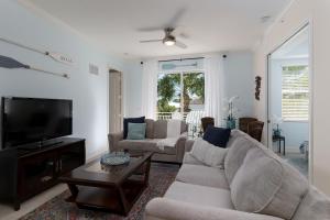 a living room with a couch and a tv at - The Bonita Paddle A202 - Beautiful Bonita Springs Condo with Mother In Law Suite! condo in Bonita Springs