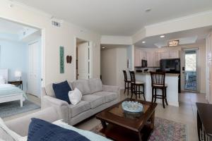 a living room with a couch and a table at - The Bonita Paddle A202 - Beautiful Bonita Springs Condo with Mother In Law Suite! condo in Bonita Springs