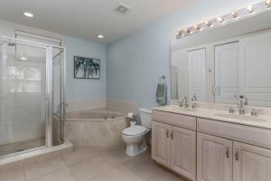 a bathroom with a toilet and a sink and a shower at -The Bonita Paddle 2 2- Your Home Away From Home in Paradise condo in Bonita Springs