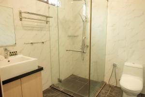 a bathroom with a shower and a sink and a toilet at Sembilan Langkawi in Kampung Padang Masirat