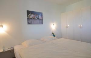 a bedroom with a bed and a painting on the wall at Appartement Seestern A in Schönhagen