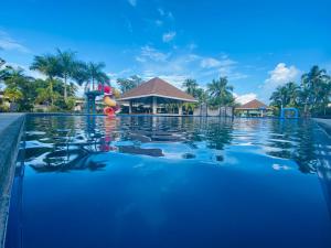 a pool at a resort with a slide at San Pedro Country Farm Resort and Event Center Inc in Cantilan