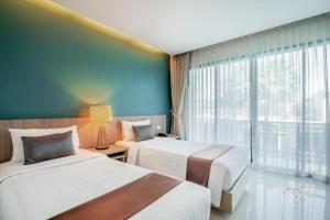 Postel nebo postele na pokoji v ubytování The Pago Design Hotel Phuket-SHA Plus