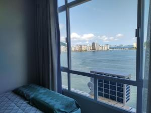a room with a window with a view of the water at Mirante de São Vicente in São Vicente