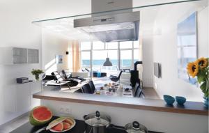 a kitchen and living room with a view of the ocean at Appartement Seestern B in Schönhagen