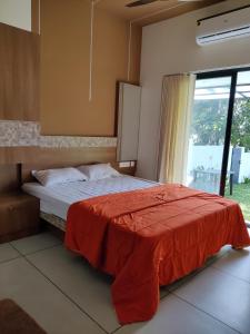 a bedroom with a bed with a red blanket at Eva Meadows in Kollam