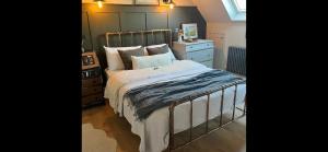 a bedroom with a bed and a dresser at Pear Tree Loft in Lacock