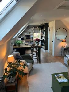 a living room with a couch and a table at Pear Tree Loft in Lacock