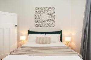 a bedroom with a large bed with two lamps at Large 4 Bed Beachside Haven 50m to Bondi Beach in Sydney