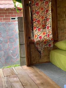 a door to a room with a curtain on it at Tetebatu Sama Sama Bungalows in Tetebatu