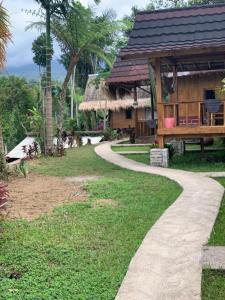 a path leading to a house with a building at Tetebatu Sama Sama Bungalows in Tetebatu