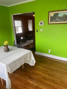 een groene kamer met een tafel en een groene muur bij Cozy comfortable PRIVATE BEDROOMS in Atlanta