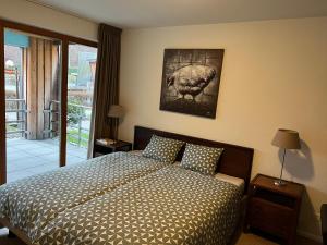 a bedroom with a bed and a picture of a turkey at Walensee Apartment, Lakeside Dream in Unterterzen