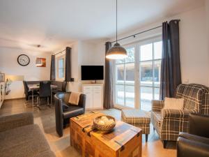 a living room with a couch and a table at Modern Apartment in Brixen im Thale near Ski Area in Feuring