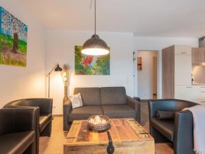 a living room with a couch and a table at Modern Apartment in Brixen im Thale near Ski Area in Feuring