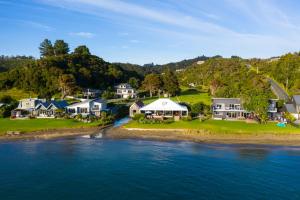 an aerial view of a house on the shore of the water at Absolute Beach front-Tutukaka Harbour in Tutukaka