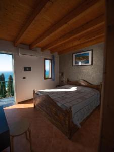 a bedroom with a bed and a large window at Agriturismo S.Ilario in Genoa