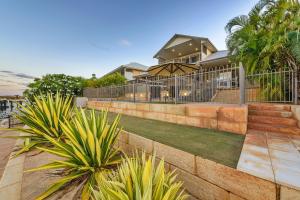 a house with a retaining wall and some plants at 7 Kestrel Place in Exmouth