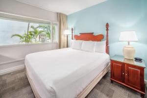 a bedroom with a large bed and a window at Maui Beach Hotel in Kahului +193 photos