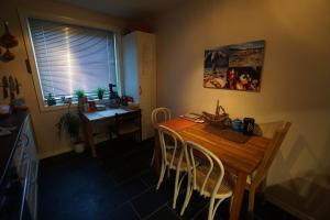 Apartement in Drammen close to the main city في درّامن: مطبخ مع طاولة وكراسي خشبية في الغرفة