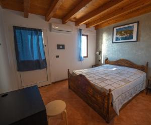 a bedroom with a bed and a table and a window at Agriturismo S.Ilario in Genoa