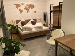 a living room with a couch with a world map on the wall at Jakobshof in Bad Mergentheim