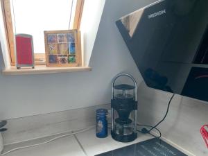 a coffee maker sitting on a counter next to a window at Ferienwohnung Ipsheim Zentral in Ipsheim