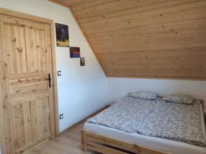 a bedroom with a bed and a wooden ceiling at Domek na Berechu Domek w Górach-Pieniny in Szlachtowa