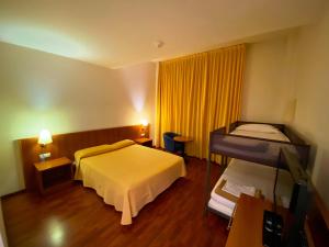 Postel nebo postele na pokoji v ubytování Hotel Berga Park