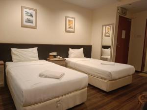 Postel nebo postele na pokoji v ubytování AMB LAI LAI HOTEL