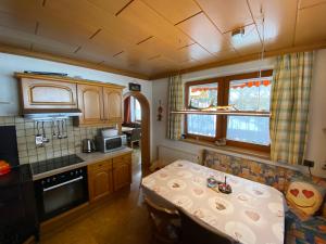 a small kitchen with a table in a room at Chalet Tauernbär in Großkirchheim