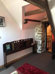 a room with a couch and a stone wall at Manoir de Parc ar Brun in Tréguier