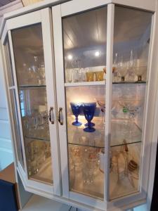 a glass cabinet with glasses in it at Tangen - cabin with 4 bedrooms - great nature in Norheimsund