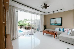 a living room with a couch and a table at The Lavana River Villas Lombok in Senggigi