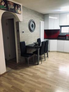 a dining room with a black table and black chairs at Villa Miami in Ashdod