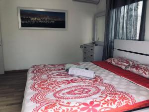 a bedroom with a bed with a red and white blanket at Villa Miami in Ashdod +38 photos
