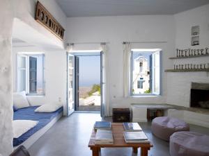 a living room with a couch and a fireplace at Kea Village Suites & Villas in Ioulis +55 photos